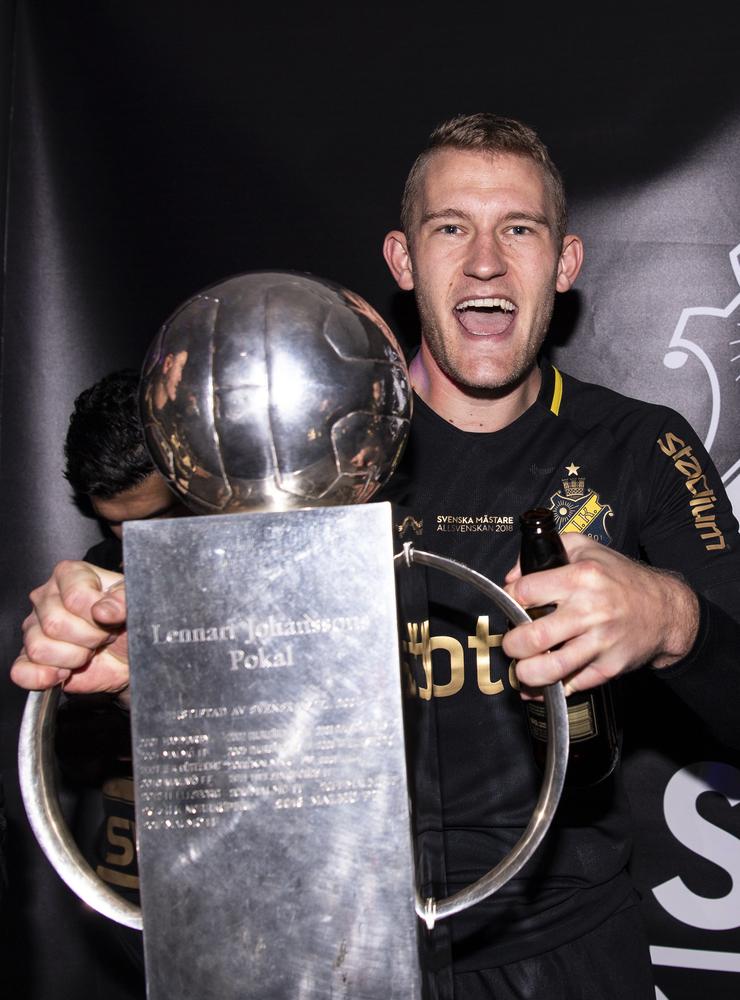 AIK:s Robin Jansson jublar med pokalen efter att de vunnit SM-guld.