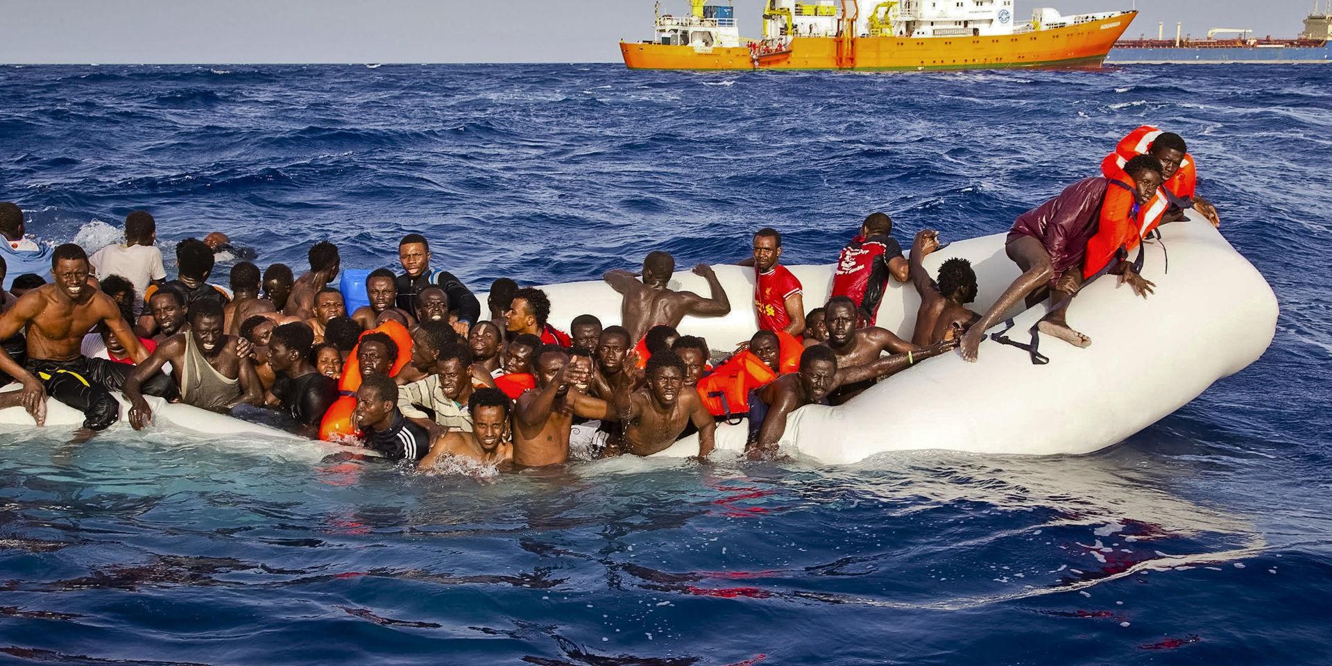 In this photo taken on Sunday, April 17, 2016 migrants ask for help from a dinghy boat as they are approached by the SOS Mediterranee&apos;s ship Aquarius, background, off the coast of the Italian island of Lampedusa. The European Union&apos;s border agency says the number of migrants crossing the Mediterranean Sea to Italy more than doubled last month. Frontex said in a statement on Monday that almost 9,600 migrants attempted the crossing, one of the most perilous sea voyages for people seeking sanctuary or jobs in Europe. (Patrick Bar/SOS Mediterranee via AP)