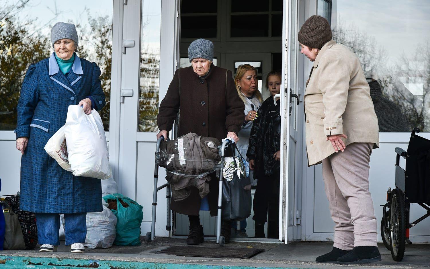 Elderly evacuees from Kherson leave their geriatric boarding house to move to the Crimea, southern Ukraine, Saturday, Nov. 5, 2022. Russian authorities have encouraged residents of Kherson to evacuate, warning that the city may come under massive Ukrainian shelling. (AP Photo)  XAZ116
