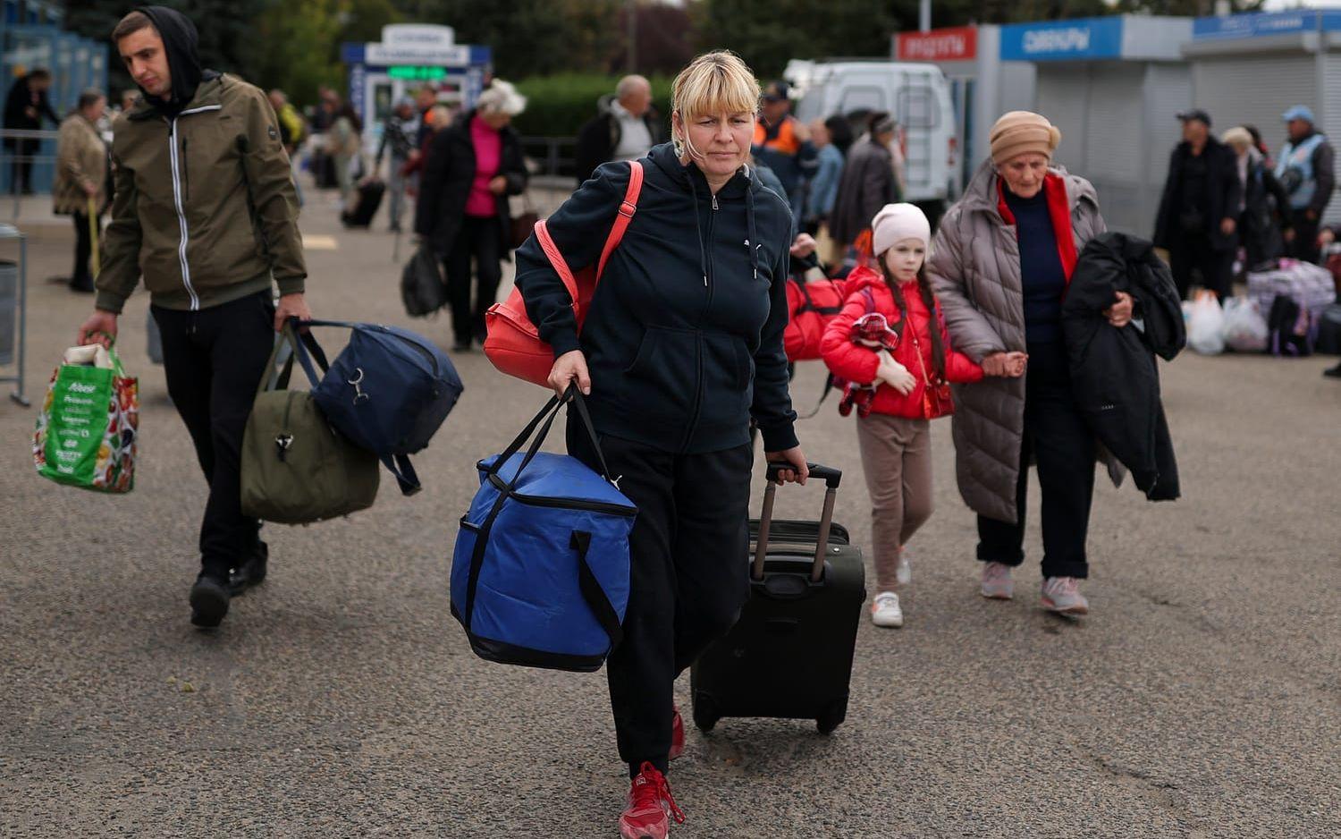 Evacuees from Kherson gather upon their arrival at the railway station in Anapa, southern Russia, Tuesday, Oct. 25, 2022. Russian authorities have encouraged residents of Kherson to evacuate, warning that the city may come under massive Ukrainian shelling. (AP Photo)  XAZ124