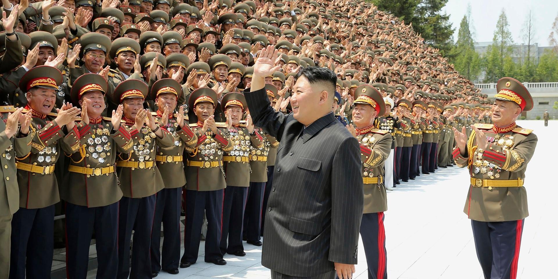 In this photo provided by the North Korean government, North Korean leader Kim Jong Un waves to participants in a workshop of the commanders and political officers of the Korean People's Army, in Pyongyang, North Korea, on July 27, 2021.