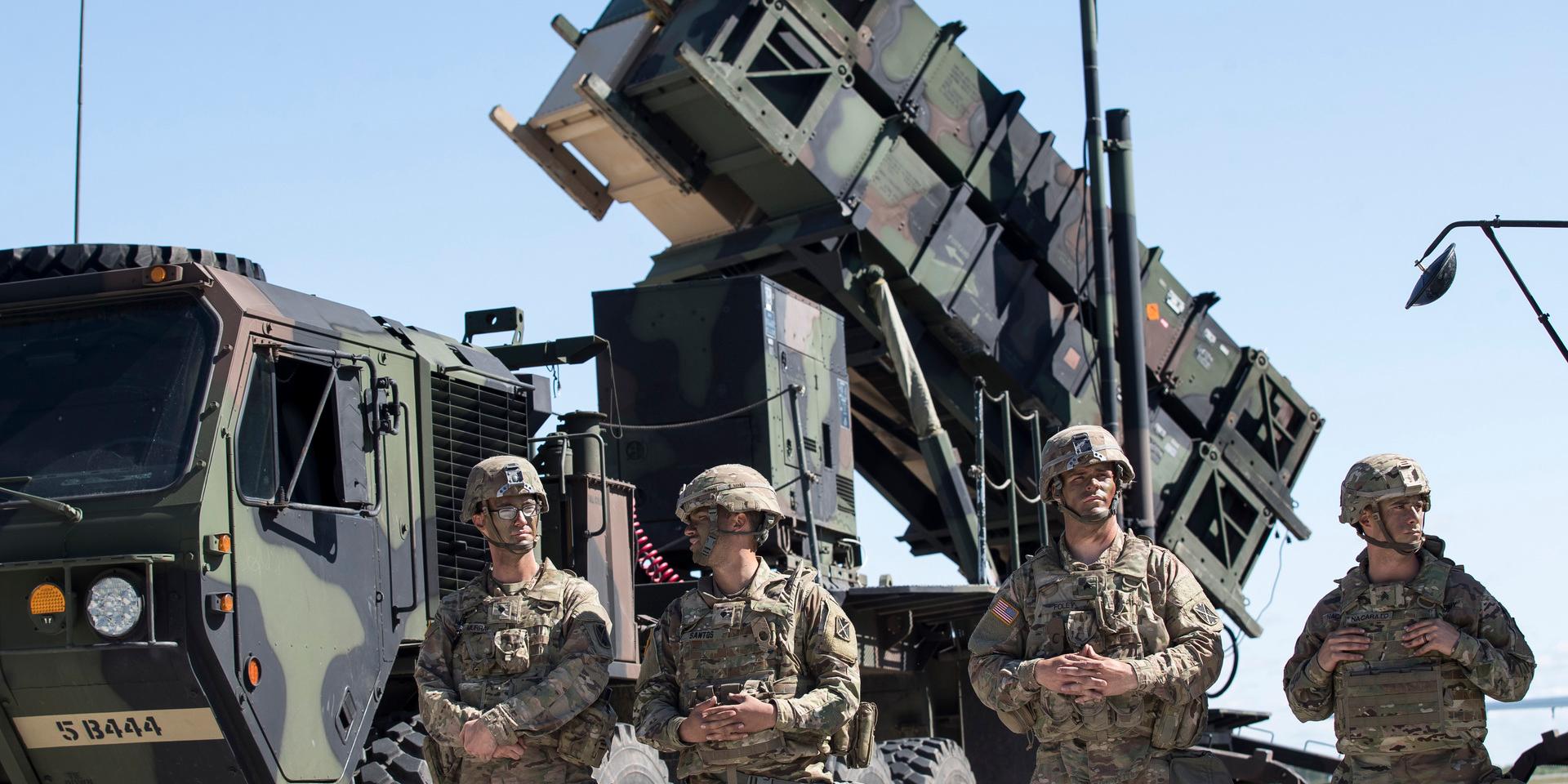 Members of US 10th Army Air and Missile Defense Command stands next to a Patriot surface-to-air missile battery during the NATO multinational ground based air defence units exercise "Tobruq Legacy 2017" at the Siauliai airbase some 230 km. (144 miles) east of the capital Vilnius, Lithuania, Thursday, July 20, 2017.  The July deployment of US Patriot long-range missile system in Lithuania, demonstrates commitment to the security of Lithuania and adds to the strategic capabilities of the region. ((AP Photo/Mindaugas Kulbis)