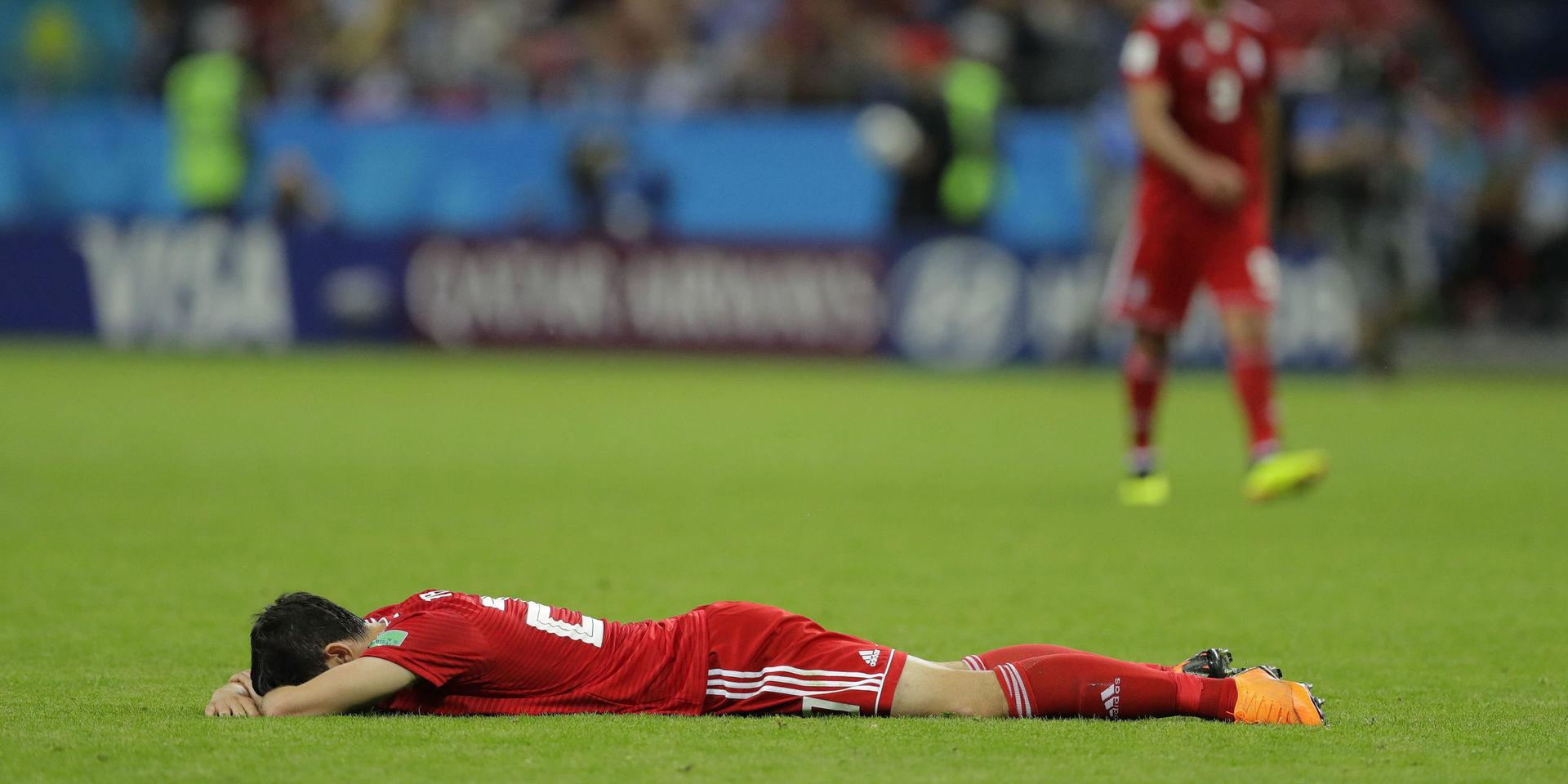 Iran&apos;s Sardar Azmoun lies flat out in the ground after the end of the group B match between Iran and Spain at the 2018 soccer World Cup in the Kazan Arena in Kazan, Russia, Wednesday, June 20, 2018. Spain won the game 1-0. (AP Photo/Sergei Grits)