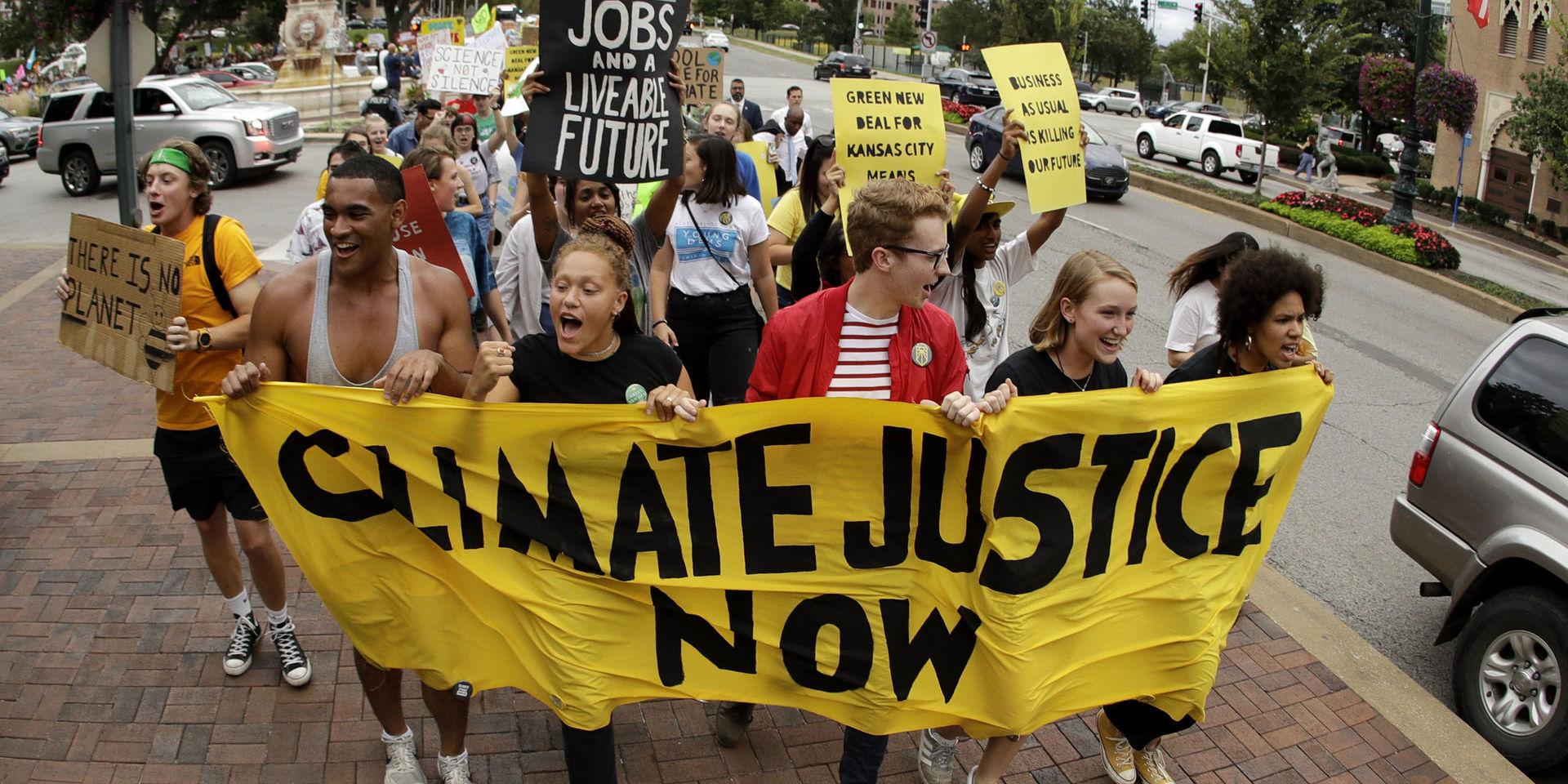 Climate protesters demonstrate Friday, Sept. 20, 2019, in Kansas City, Mo. Across the globe, people took to the streets Friday to demand that leaders tackle climate change in the run-up to a U.N. summit. (AP Photo/Charlie Riedel)  MOCR109