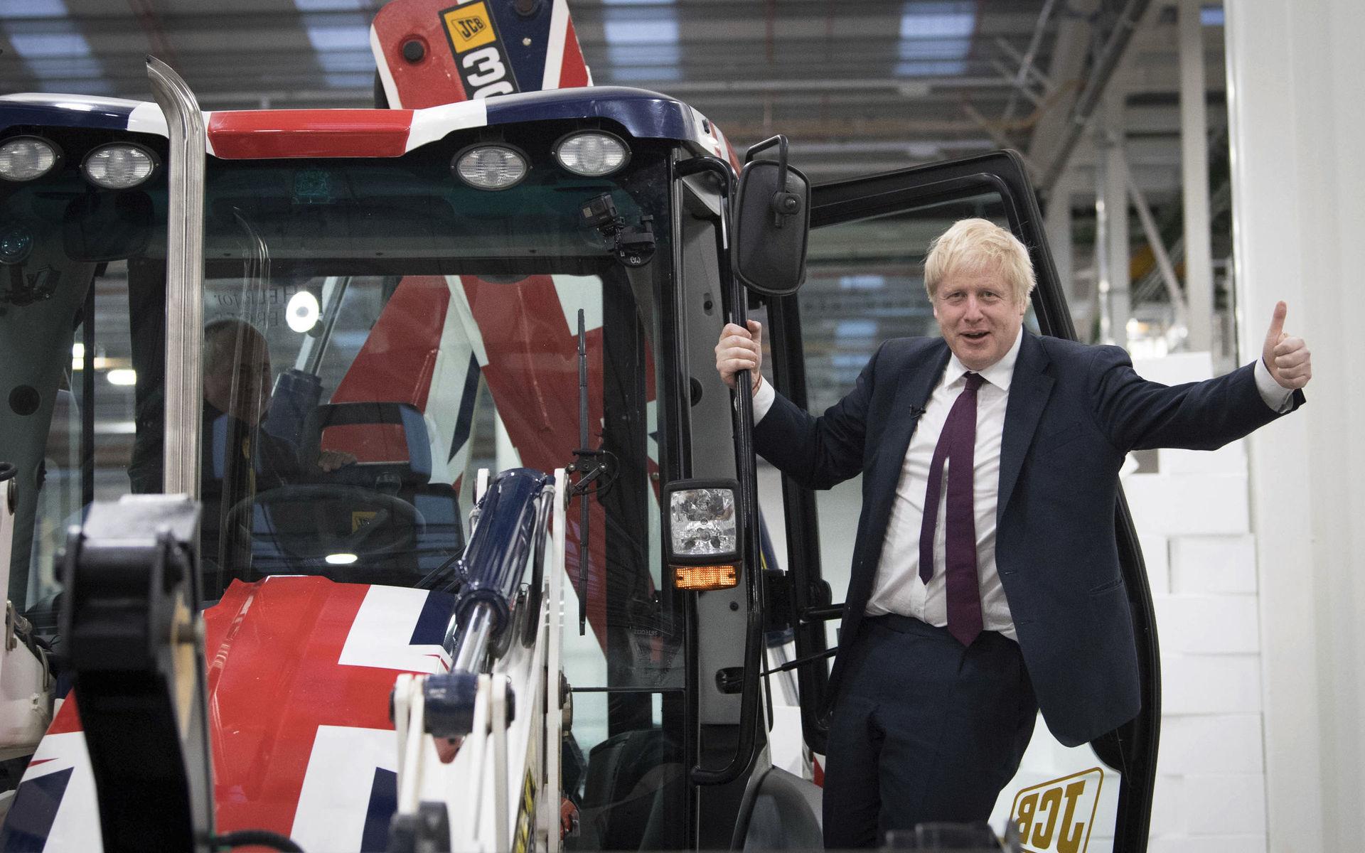 Britain&apos;s Prime Minister Boris Johnson signals to the media during an election campaign visit to the JCB manufacturing facility in Uttoxeter, England, Tuesday Dec. 10, 2019.  The Conservative Party are campaigning for their Brexit split with Europe ahead of the UK&apos;s General Election on Dec. 12.(Stefan Rousseau/PA via AP)  WRC828