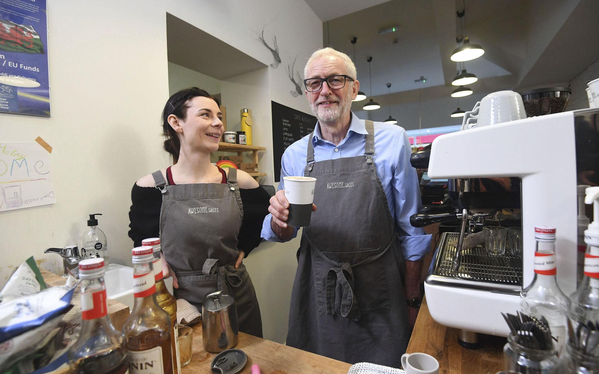 Labour Party leader Jeremy Corbyn poses for a photo in a coffee shop to mark Small Business Saturday, while on the General Election campaign trail in Barry, Wales, Saturday, Dec. 7, 2019. Britain goes to the polls on Dec. 12  (Victoria Jones/PA via AP)  LON802
