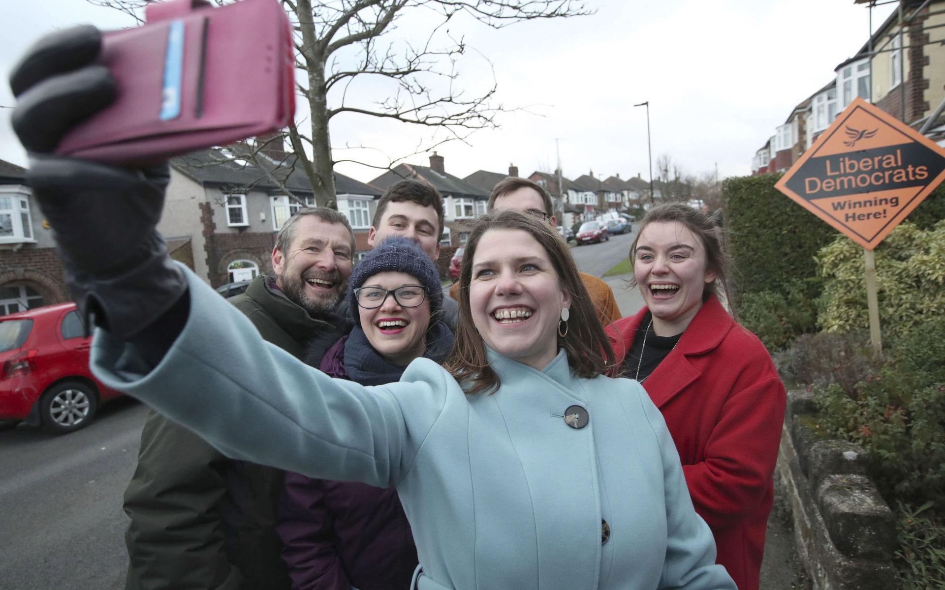 Liberal Democrat Leader Jo Swinson takes a selfie with supporters as she canvasses, while on the General Election campaign, in Sheffield, England, Sunday, Dec. 8, 2019. Britain goes to the polls on Dec. 12. (Danny Lawson/PA via AP)  AMB861