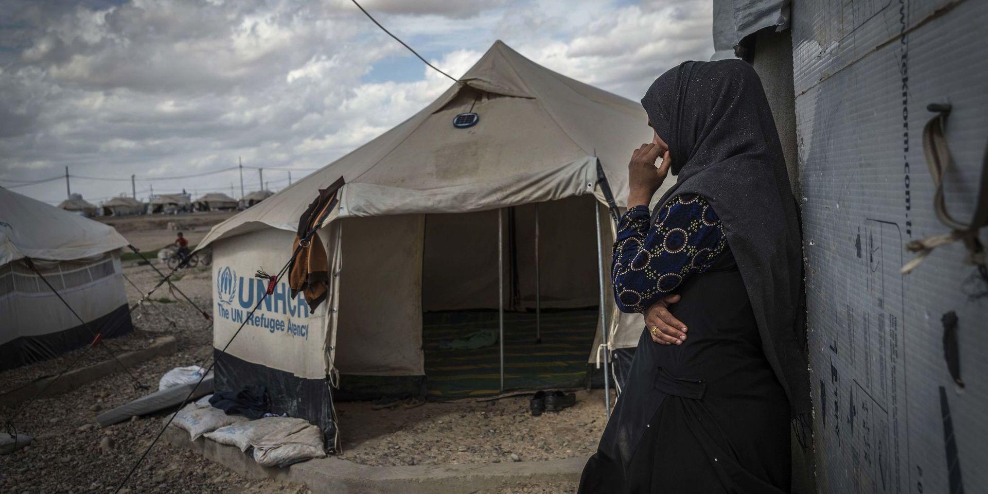 This photo released by Amnesty International on Tuesday, April 18, 2018 shows 33-year-old mother of six, Zahra, outside a tent used for cooking inside in Salamiya camp for internally displaced people where she and her family have lived for 7 months. Originally from Shwra, south of Mosul, she and her family moved to Mosul three years ago after her husband joined ISIS, working with the group as a cook. He was killed by an airstrike in June 2017. Amnesty says its report details the predicament of thousands of female-led families left to fend for themselves in displaced camps after male family members were killed, arbitrarily arrested or forcibly disappeared. (Claire Thomas/Amnesty International via AP)