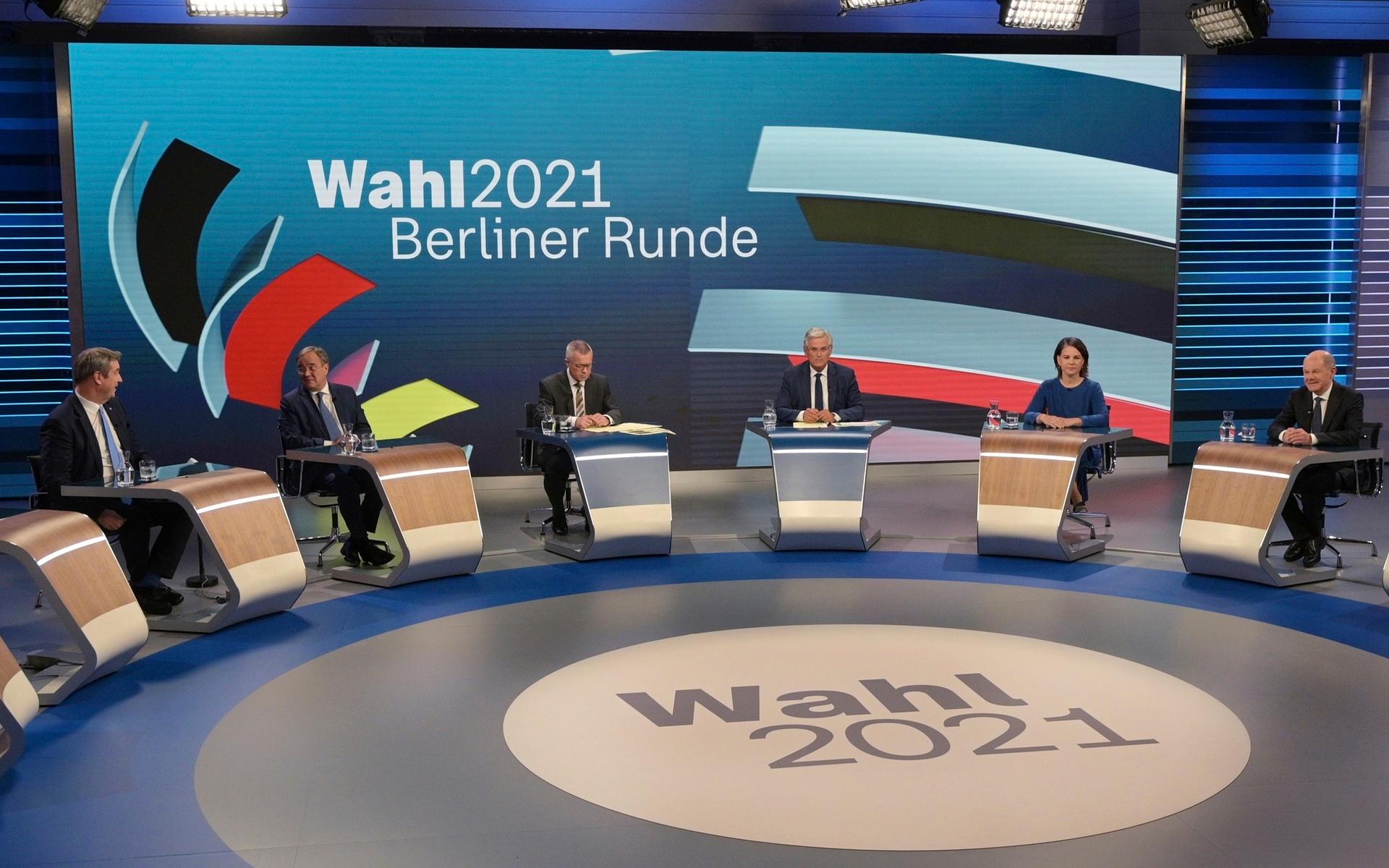 From left: CSU leader Markus Soeder, Armin Laschet of the CDU, the CDU/CSU&apos;s candidate for chancellor, moderators Rainald Becker and Peter Frey, Annalena Baerbock, candidate for chancellor of the Green Party, Olaf Scholz, candidate for chancellor of the SPD, prepare to talk about the Bundestag election in an election studio of ZDF at the &quot;Berliner Runde&quot; Sunday Sept. 2021 in Berlin. Projections show Germany’s center-left Social Democrats locked in a very close race with outgoing German Chancellor Angela Merkel’s center-right bloc, which is heading toward its worst-ever result in the country’s parliamentary election. (Sebastian Gollnow/Pool via AP)  TH111