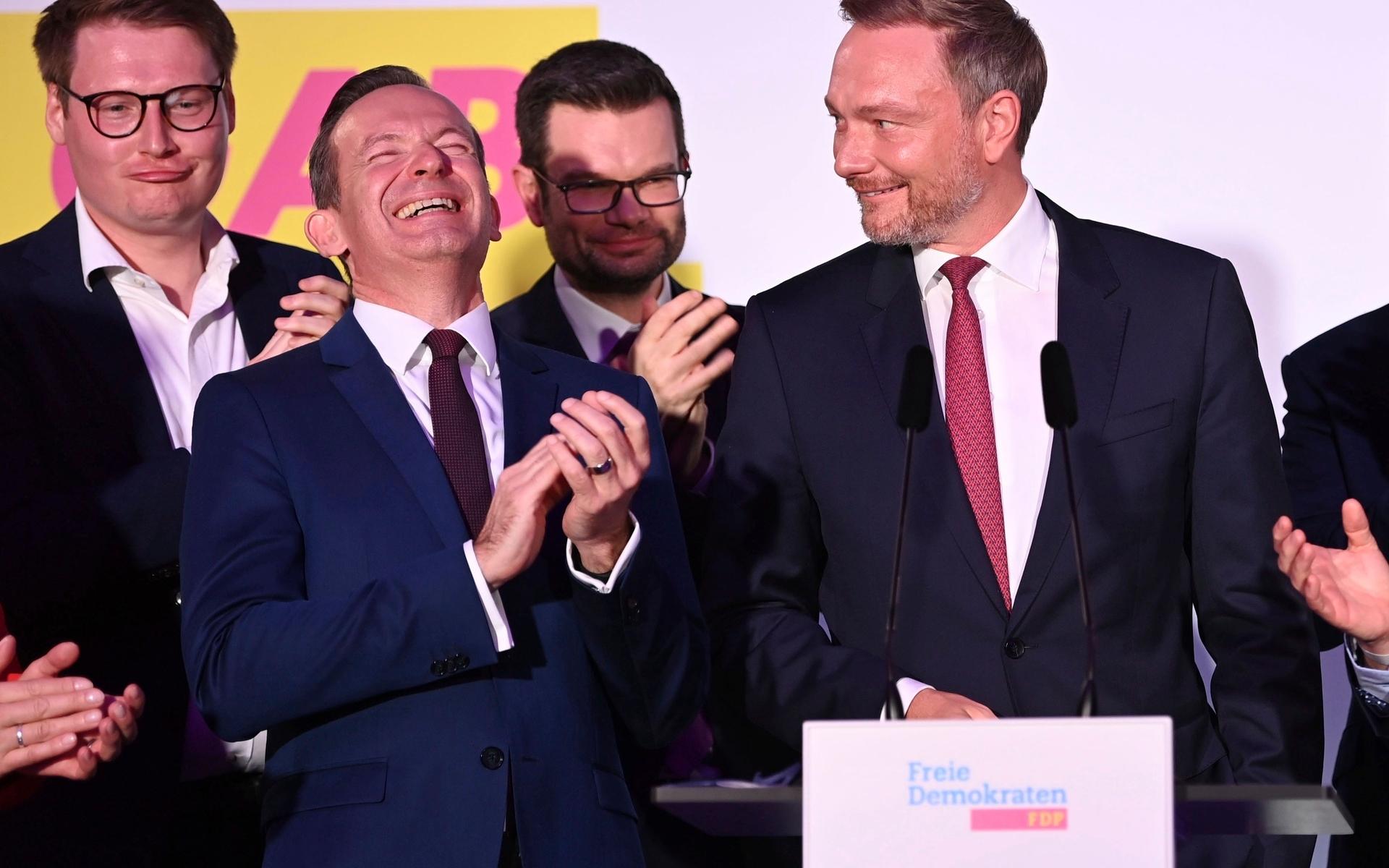 Christian Lindner, right, FDP party leader, and the Liberal party leadership stand on stage at the FDP election party fter the first forecasts were announced, in Berlin, Sunday, Sept. 26, 2021. Next to Lindner, Volker Wissing, FDP Secretary-General. Exit polls show the center-left Social Democrats in a very close race with outgoing Chancellor Angela Merkel’s bloc in Germany’s parliamentary election, which will determine who succeeds the long-time leader after 16 years in power. (Sebastian Kahnert/dpa via AP)  LFP337