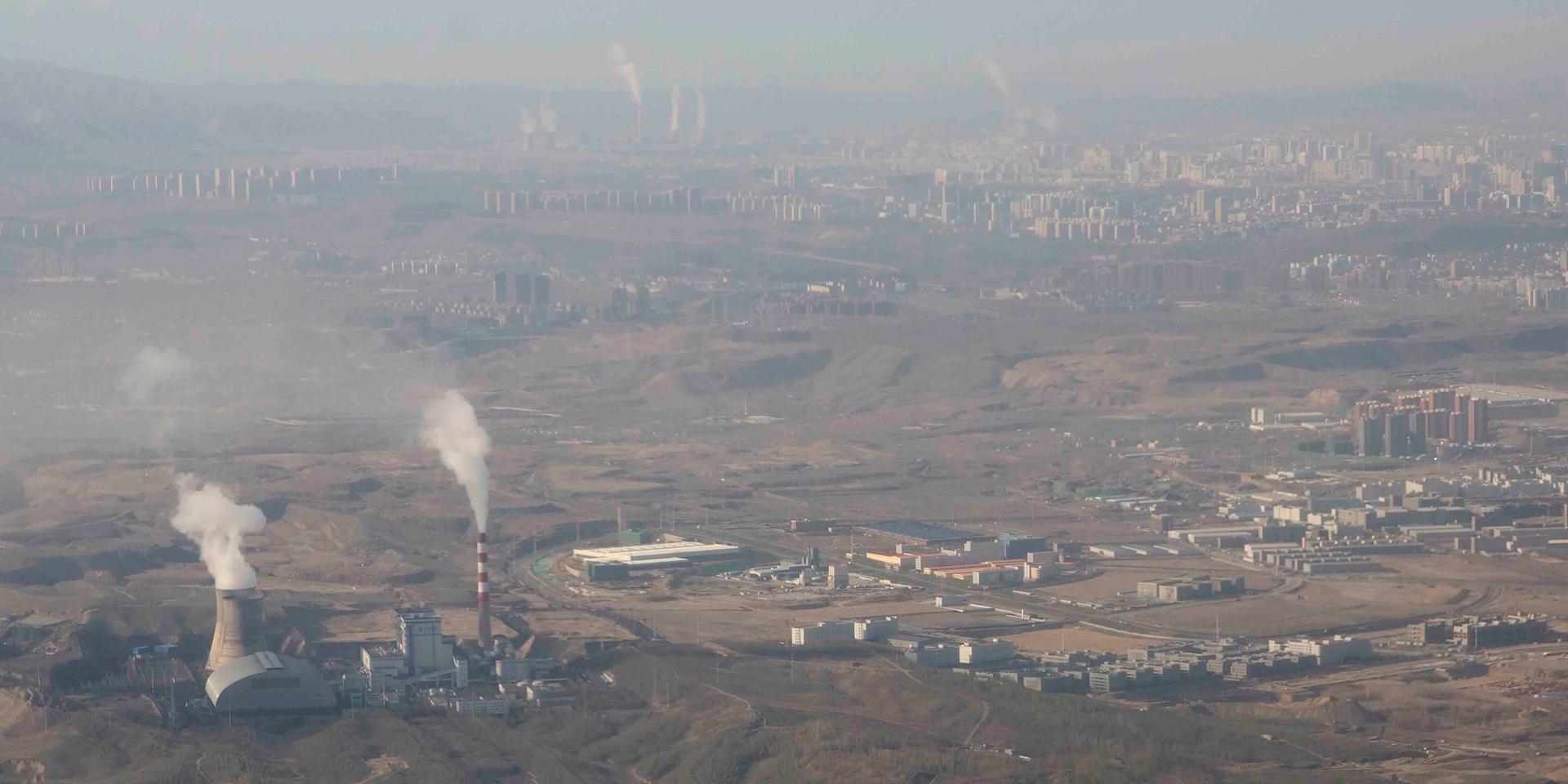 Smoke and steam rise from towers at the coal-fired Urumqi Thermal Power Plant in Urumqi in western China's Xinjiang Uyghur Autonomous Region, Wednesday, April 21, 2021. China, the world's biggest coal user, said Tuesday the fossil fuel will play a less dominant role in its energy mix and that, despite plans to build new coal-fired power plants, the country won't use it on a wide scale. (AP Photo/Mark Schiefelbein)  XMAS202