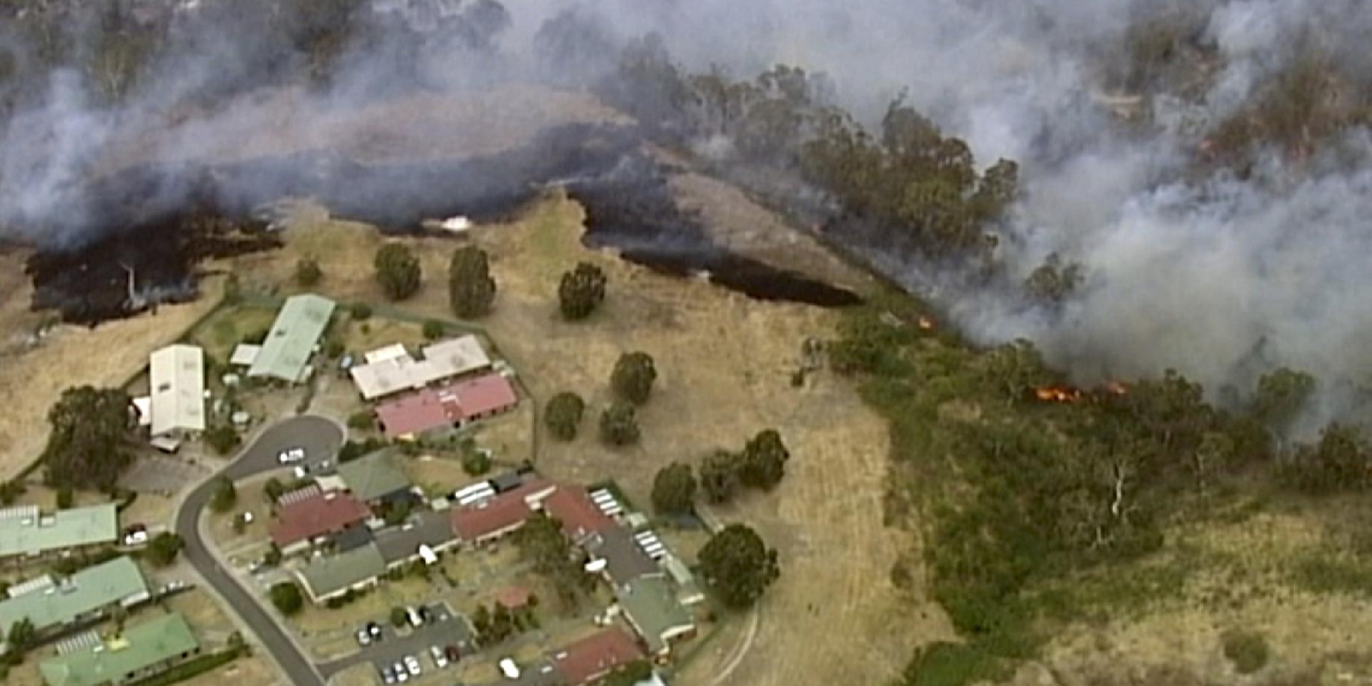 In this image made from video, an aerial scene shows fires burning and smoke rising close to properties in Bundoora, Victoria state, Monday, Dec. 30, 2019. New Year’s Eve fireworks in Australia’s capital and other cities have been canceled as the wildfire danger worsens in oppressive summer heat, and pressure was building for Sydney’s iconic celebrations to be similarly scrapped. (Australian Broadcasting Corporation, Channel 7, Channel 9 via AP)  TKSJ801