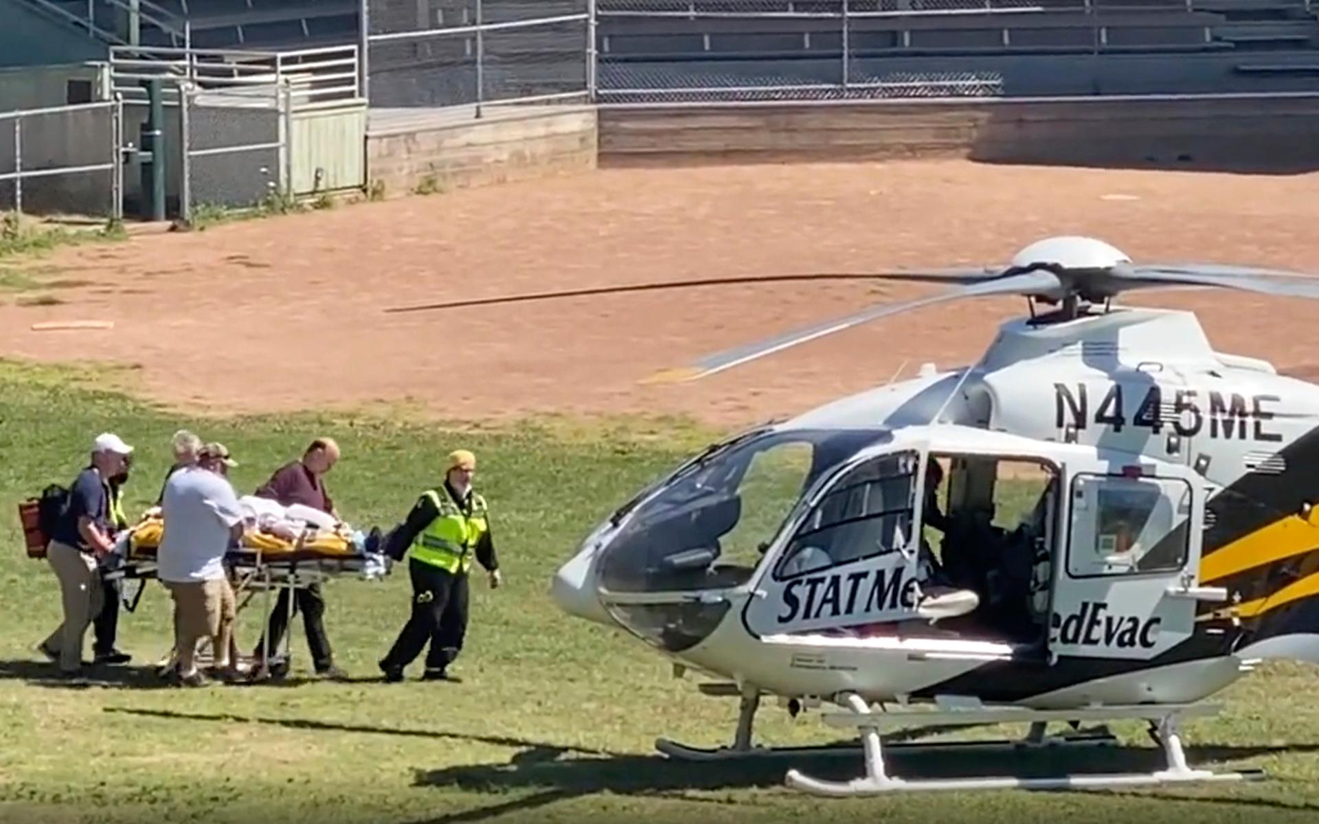 In this still image from video, author Salman Rushdie is taken on a stretcher to a helicopter for transport to a hospital after he was attacked during a lecture at the Chautauqua Institution in Chautauqua, N.Y., Friday, Aug. 12, 2022. (AP Photo)  NYAJ501