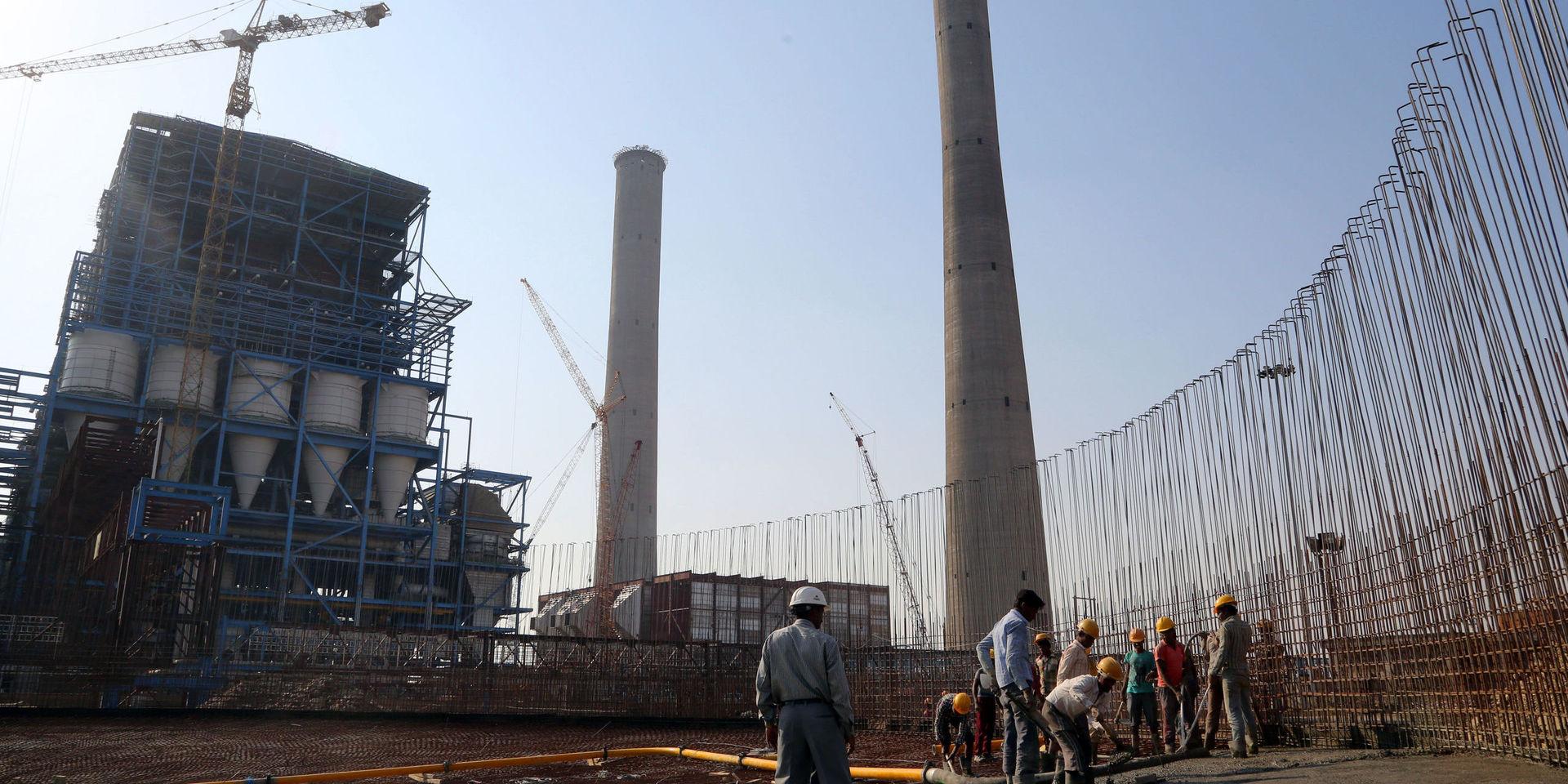 FILE - In this Feb. 24, 2015 file photo, workers lay cement to build a concrete structure at the under-construction coal-fired power plant, partially financed by the Japan Bank for International Cooperation, in Kudgi, India. A compromise struck by the United States, Japan and several other major nations will restrict export financing to build coal power plants overseas, but not eliminate it completely. The agreement reached Tuesday, Nov. 17 is an important step forward that sends a strong political message ahead of upcoming international climate change negotiations in Paris, an American official and environmentalists said. (AP Photo/Aijaz Rahi, File)