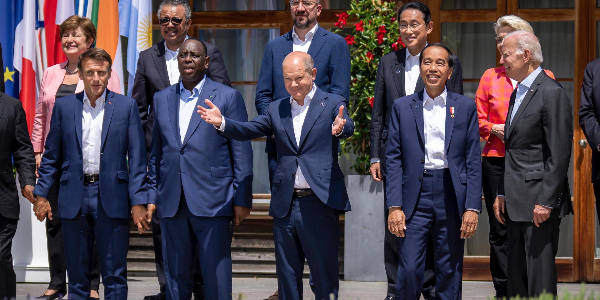 German Chancellor Olaf Scholz, centre stands between from foreground left, Emmanuel Macron, President of France, Macky Sall, President of Senegal, Jako Widodo, President of Indonesia, and U.S. President Joe Biden for a group photo with the outreach guests, at the G7 summit, in Kruen, Germany, Monday, June 27, 2022. . The Group of Seven leading economic powers are meeting in Germany for their annual gathering Sunday through Tuesday. (Michael Kappeler/Pool Photo via AP)  AMB106