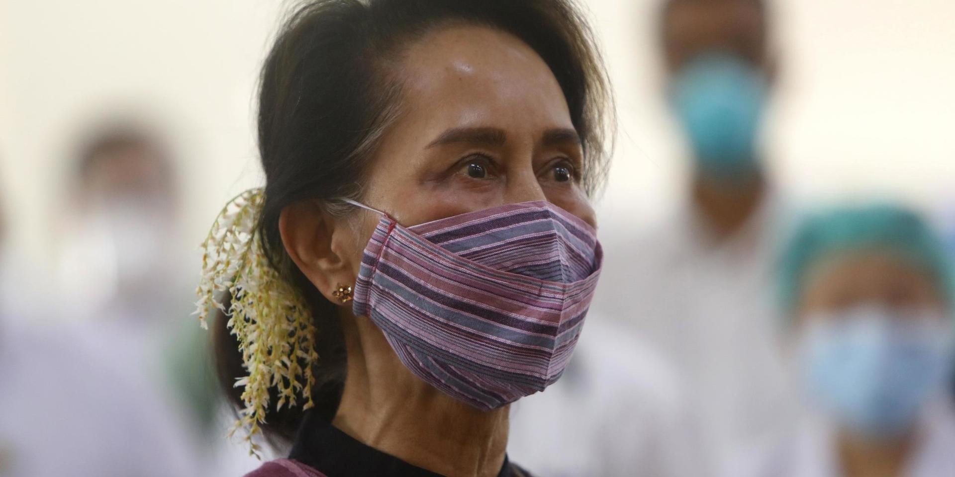 FILE - In this Jan 27, 2021, file photo, Myanmar leader Aung San Suu Kyi watches the vaccination of health workers at hospital in Naypyitaw, Myanmar. Reports says Monday, Feb. 1, 2021 a military coup has taken place in Myanmar and Suu Kyi has been detained under house arrest. (AP Photo/Aung Shine Oo, File)  XKS102