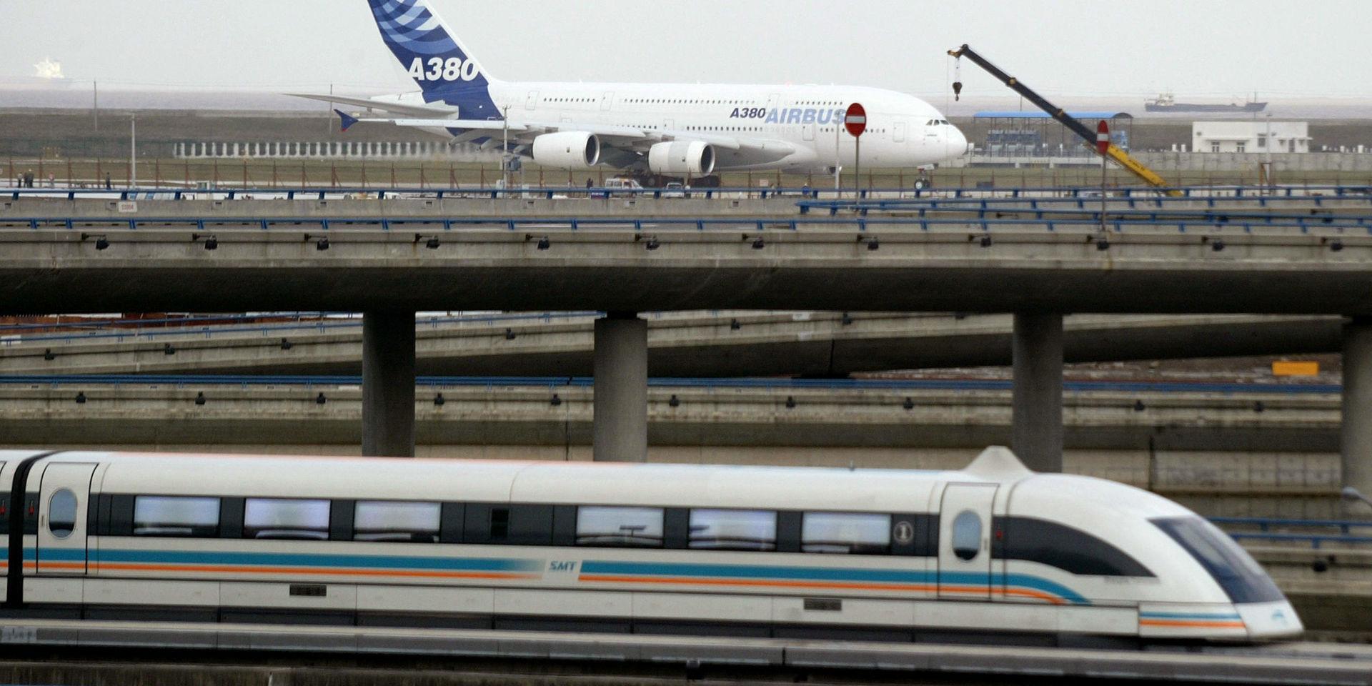 A maglev train runs past as a new Airbus A380 sits on the tarmac at Shanghai Pudong International Airport Friday Nov. 24, 2006 in Shanghai, China. The Airbus A380 superjumbo flew home Friday after stopovers in three of China&apos;s biggest cities, visits symbolizing the company&apos;s ambitions in the booming Chinese market, where the outlook for the colossal jet is mixed. (AP Photo/Color China Photo) ** CHINA OUT **