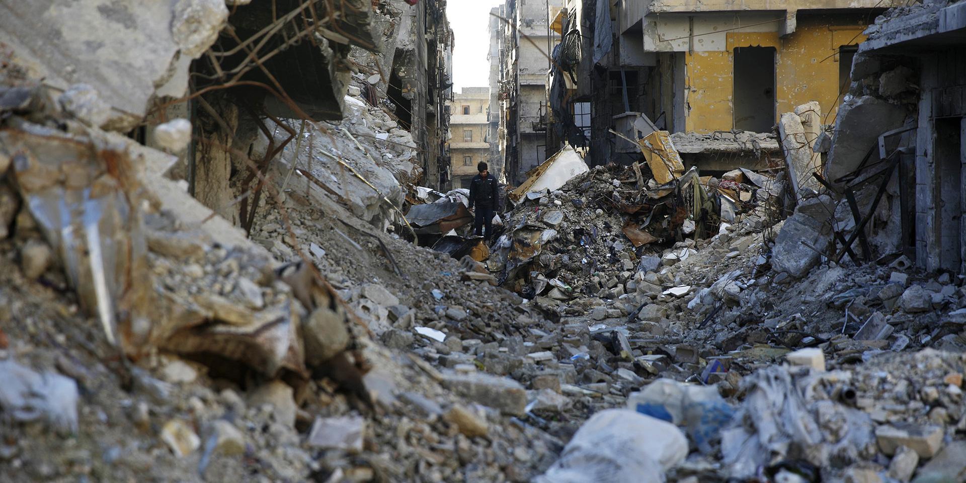 A Syrian walks through the destruction of the Salaheddine neighborhood in the eastern Aleppo, Syria, Saturday, Jan. 20, 2018. Turkey&apos;s military fired into a Kurdish-run enclave in north Syria for a second day on Saturday, one day after the country&apos;s defense minister announced an operation to &quot;cleanse&quot; the Kurdish militia in control of the enclave. (AP Photo/Hassan Ammar)