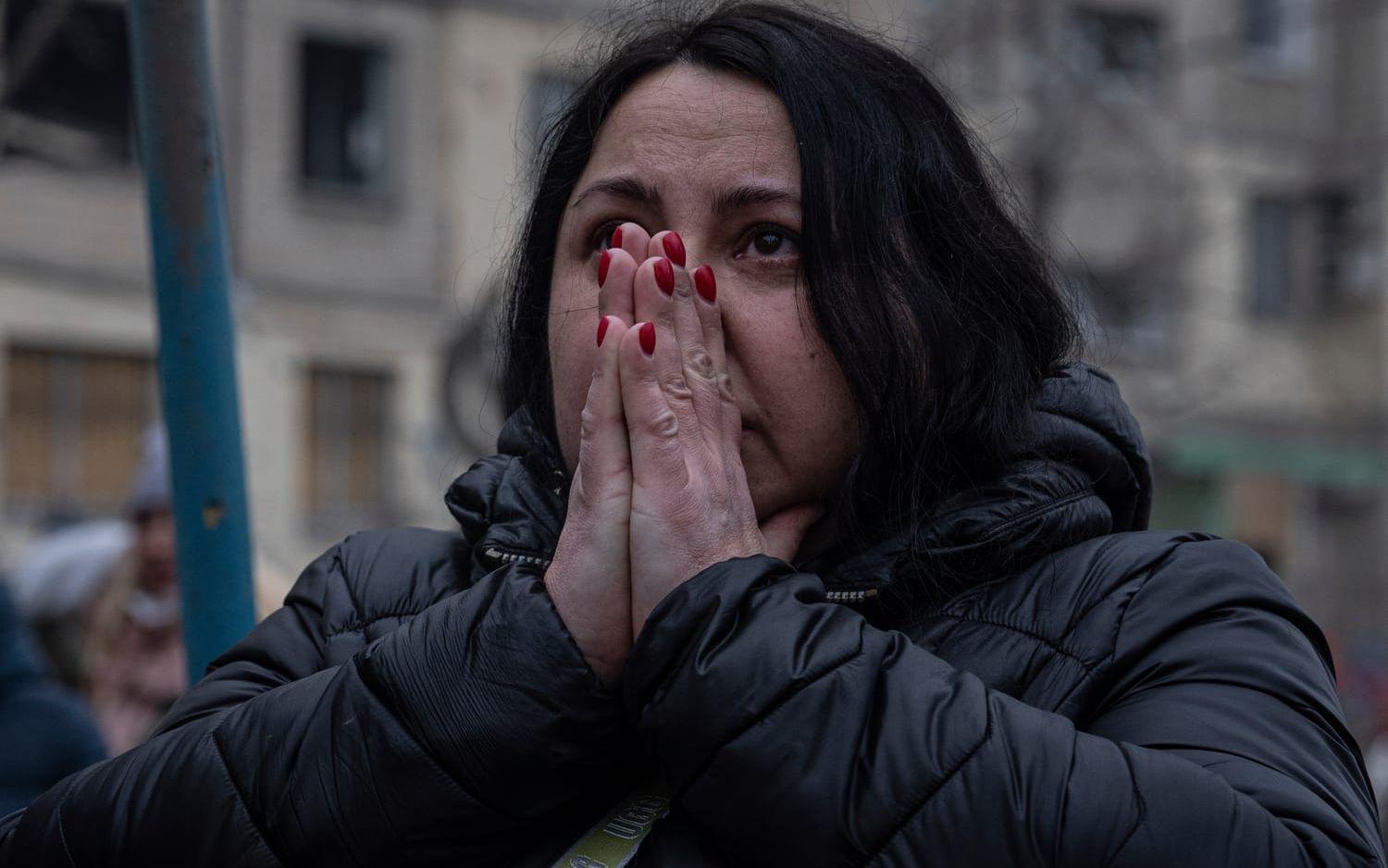 A woman reacts looking at the damage caused to an apartment building that was destroyed in a Russian rocket attack at a residential neighbourhood in the southeastern city of Dnipro, Ukraine, Sunday, Jan. 15, 2023. (AP Photo/Evgeniy Maloletka)  MAL105