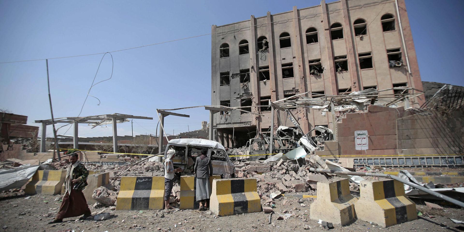 People inspect rubble after a Saudi-led coalition airstrike in Sanaa, Yemen, Sunday, Feb. 4, 2018. Yemeni rebels say an air raid by the coalition fighting them struck a police building in the rebel-controlled capital, Sanaa, killing at least eight people. In a statement by their military media unit, the rebels, known as Houthis, say that a child was killed in the Sunday attack that badly damaged a department of records building and wounding over 50 people. (AP Photo/Hani Mohammed)