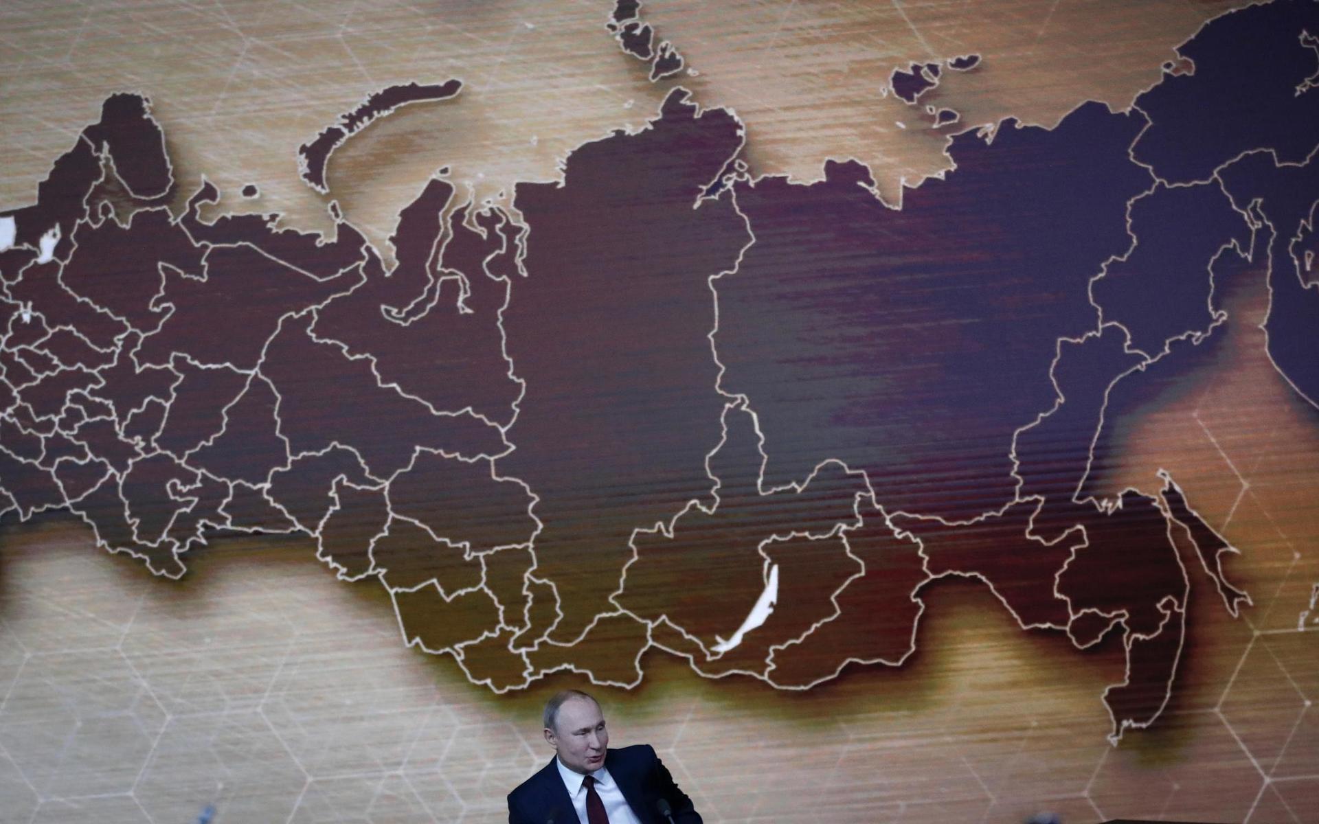 Russian President Vladimir Putin speaks during his annual news conference in Moscow, Russia, Thursday, Dec. 19, 2019. Putin says that global climate change poses new challenges to Russia. Speaking at his annual news conference Thursday, Putin said that global warming could threaten Russian Arctic cities and towns built on permafrost.  (AP Photo/Pavel Golovkin)  XDL110