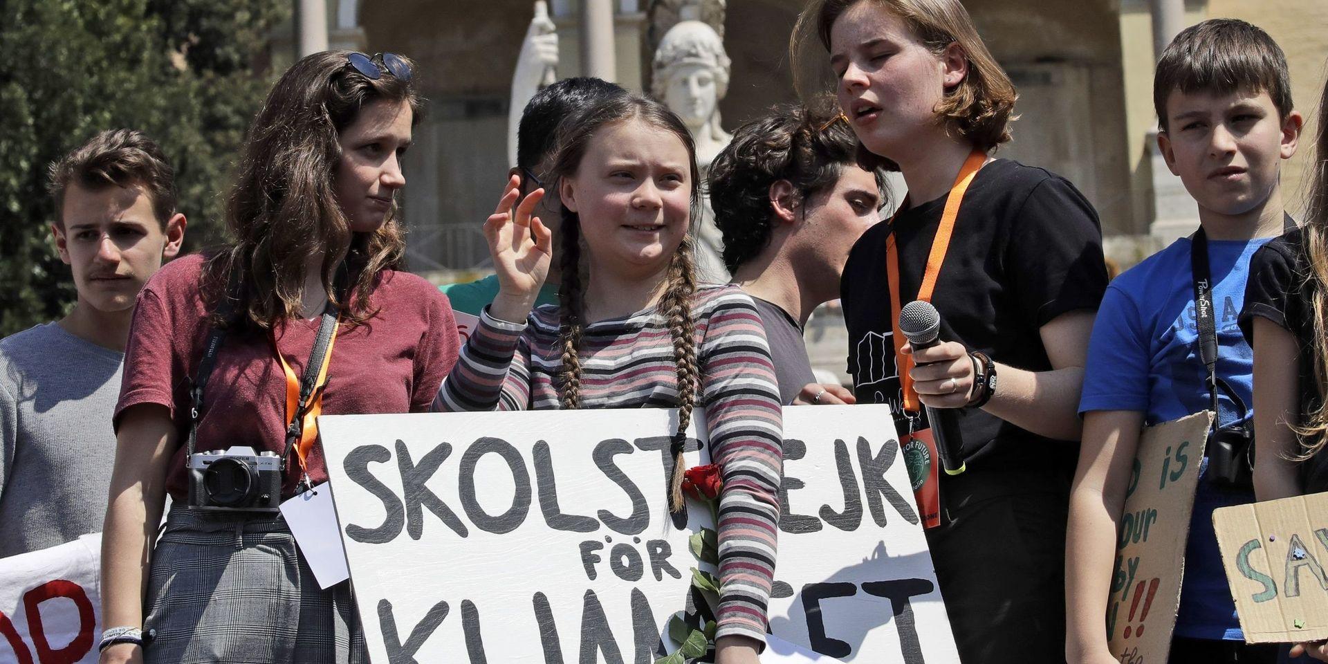 Swedish teenager and environmental activist Greta Thunberg waves as she holds a sign with writing reading in Swedish &quot;School strike for the climate&quot; during a Fridays for Future rally demanding more action be taken to save the environment, in Rome, Friday, April 19, 2019. Thunberg was in Rome to headline Friday&apos;s &quot;school strike,&quot; the growing worldwide youth movement she spearheaded, demanding faster action against climate change.(AP Photo/Alessandra Tarantino)